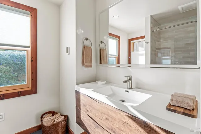 a bathroom with a granite countertop sink a toilet and shower