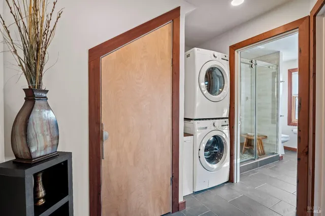 a view of a balcony with two chairs and wooden floor