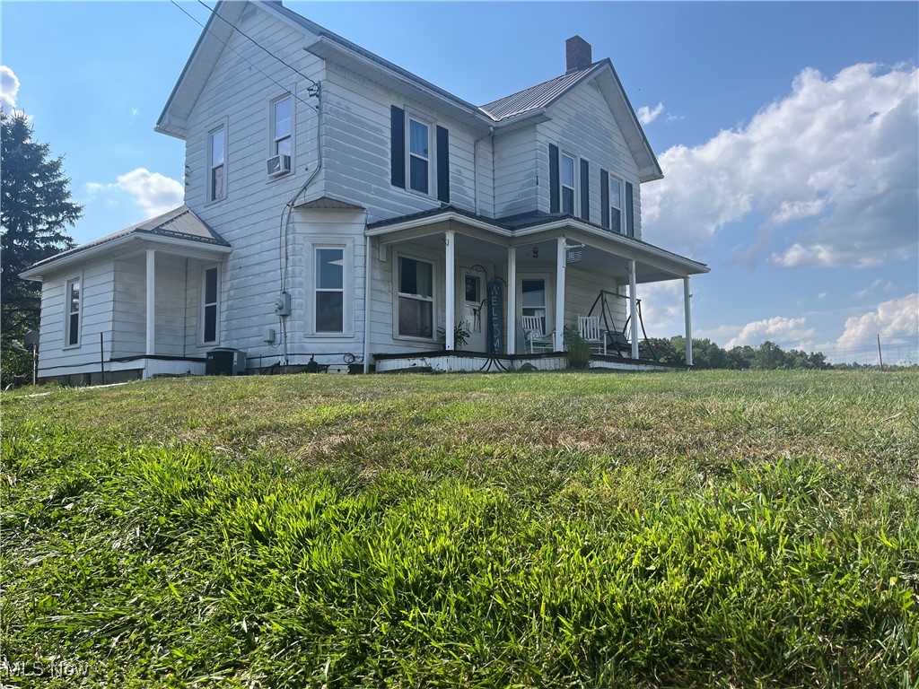 73475 Broadhead Road Kimbolton, OH 43749 - Photo 1 of 30 View of front of property with covered porch and a front lawn