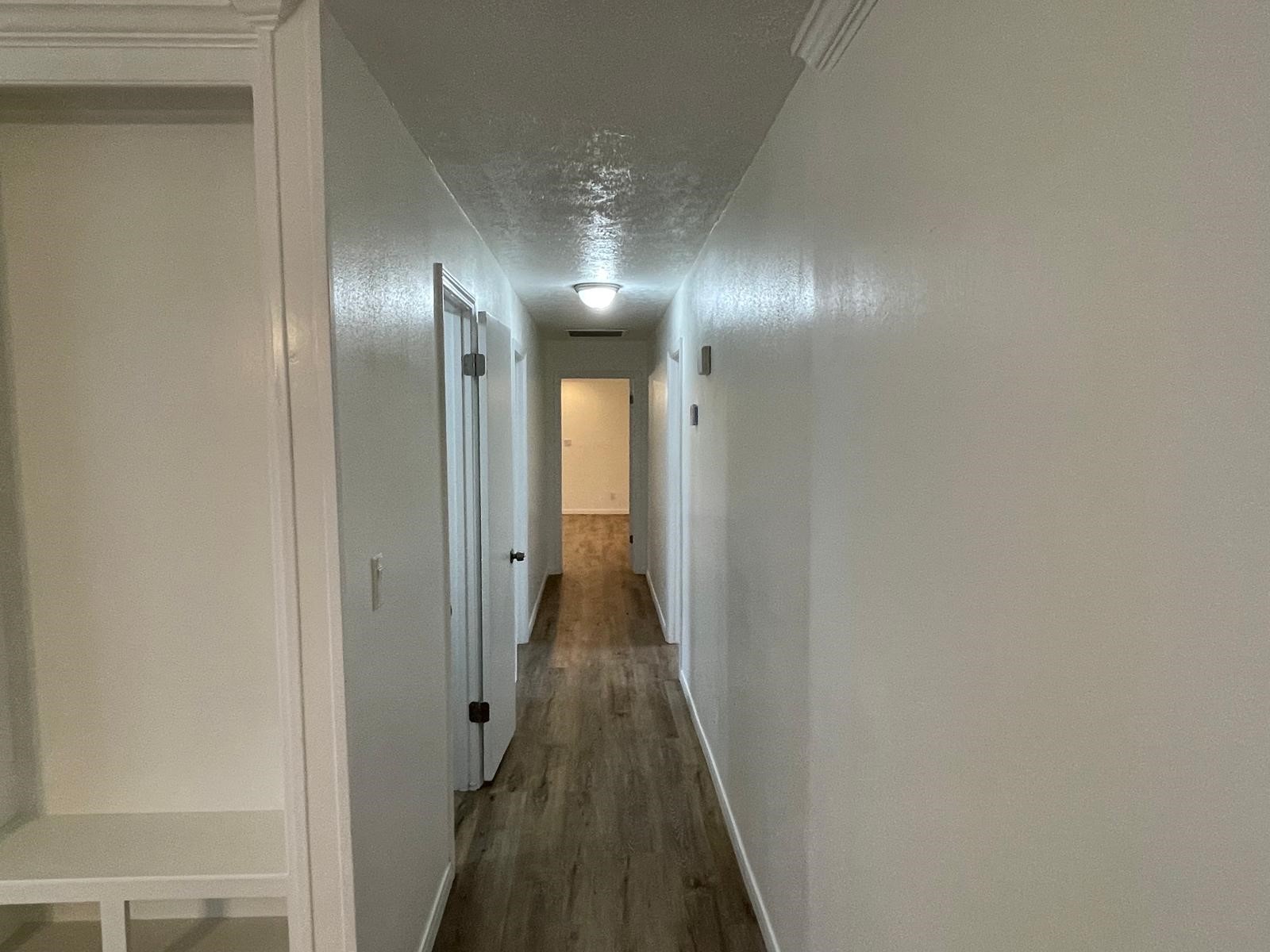 335 Carroll Road Richmond, TX 77469 - Photo 15 of 25 a view of a hallway with wooden floor