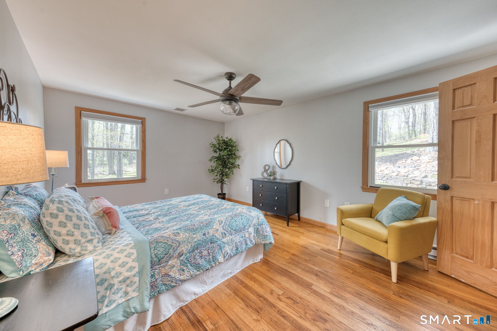 341 Main Street Middlefield, CT 06481 - Photo 11 of 30 a bedroom with a bed and a chandelier