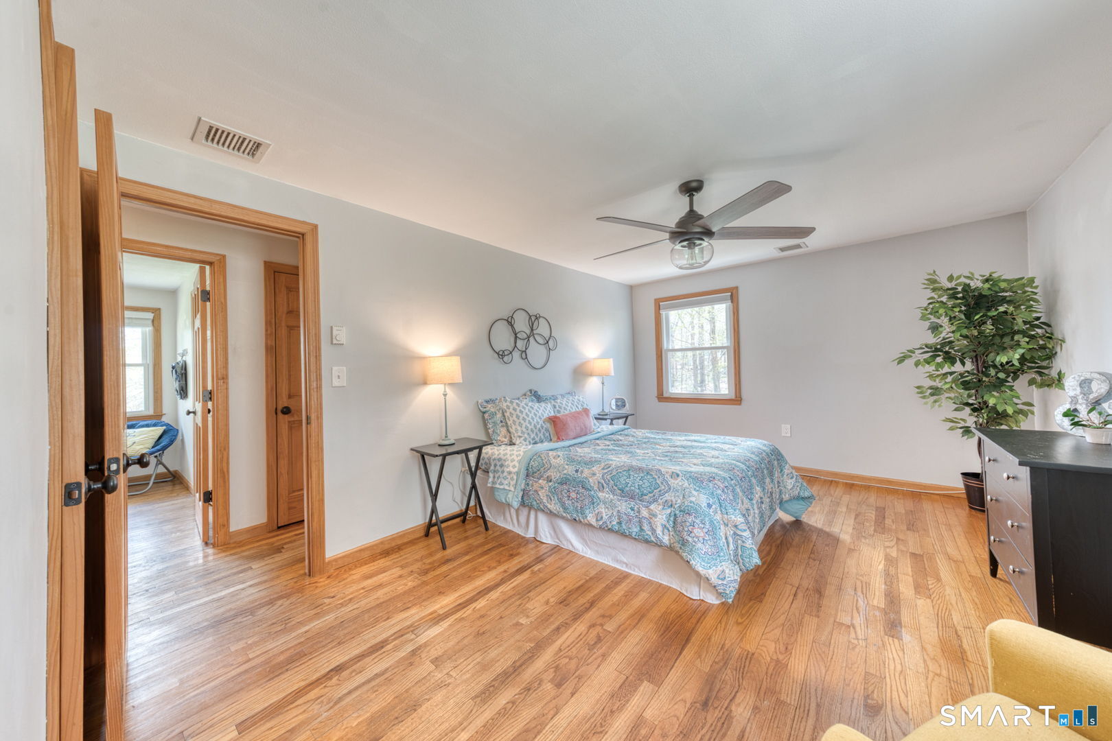 341 Main Street Middlefield, CT 06481 - Photo 12 of 30 a bedroom with a bed and a chandelier