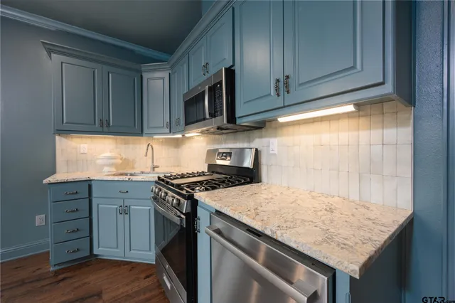 a kitchen with granite countertop wood cabinets and a stove