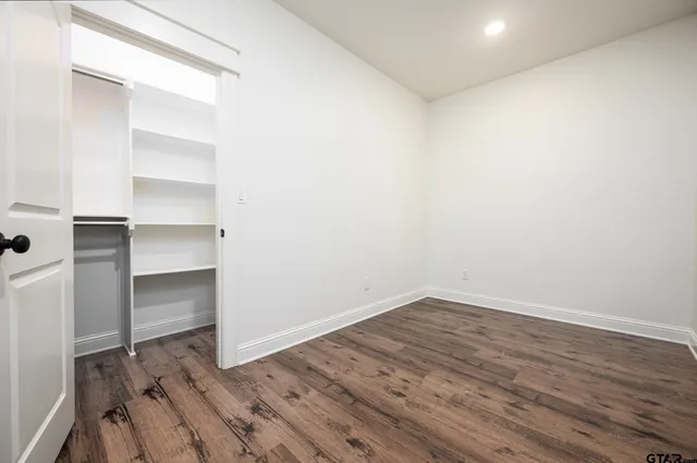 a view of a room with wooden floor