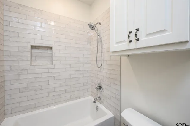 a bathroom with a bathtub and toilet