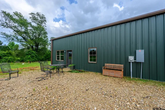 a backyard of a house with outdoor seating