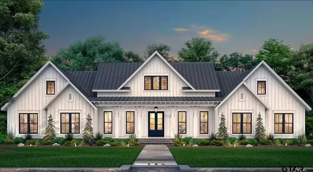 a front view of a house with yard and green space