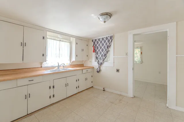 a bathroom with a granite countertop sink mirror and double