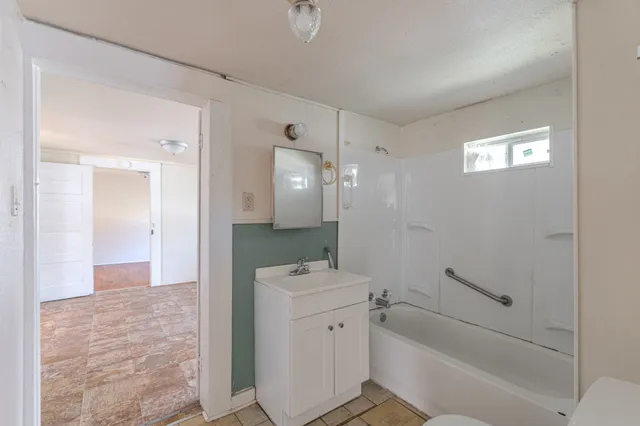 a view of an empty room and closet area