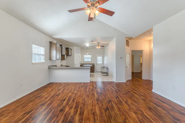 a kitchen with stainless steel appliances kitchen island granite countertop a stove top oven a sink a counter space and cabinets