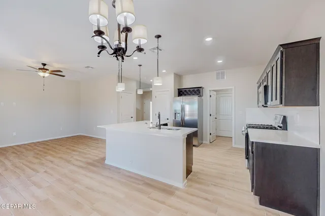 a view of kitchen with sink microwave and refrigerator