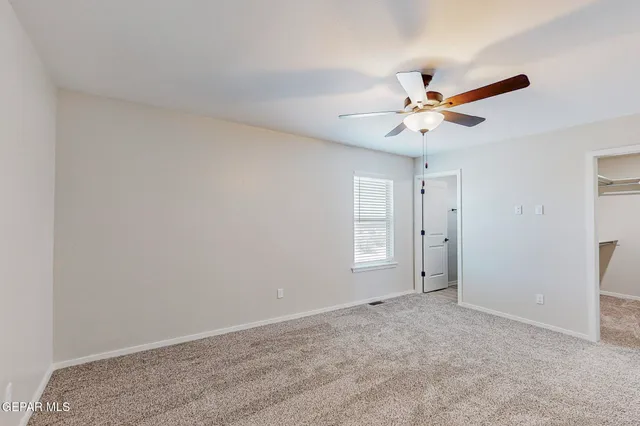 a view of a big room with chandelier fan