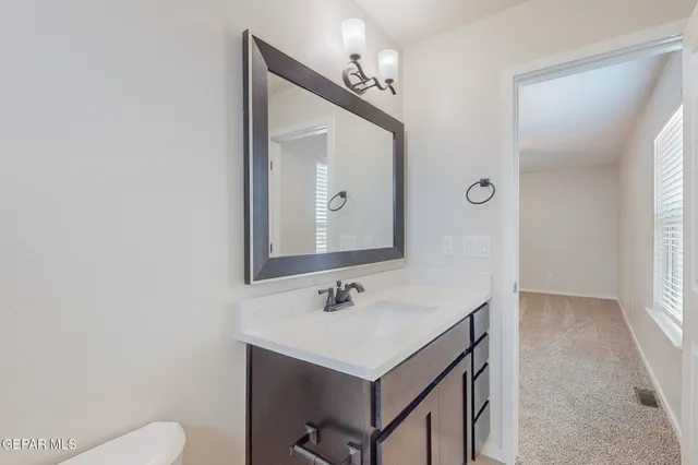 a bathroom with a sink vanity and a mirror