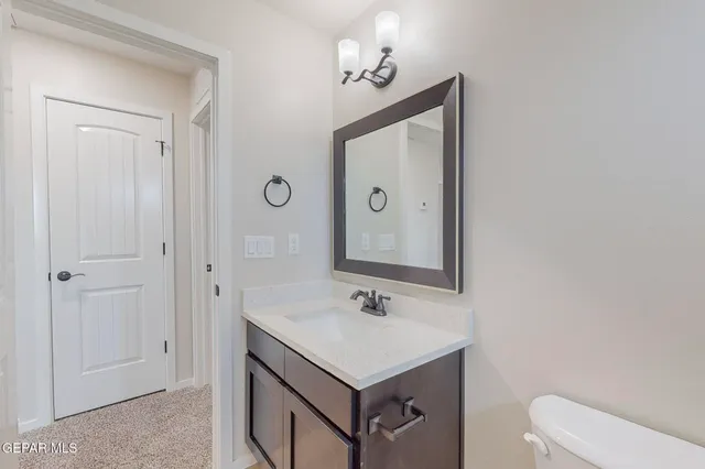 a bathroom with a sink vanity and a mirror