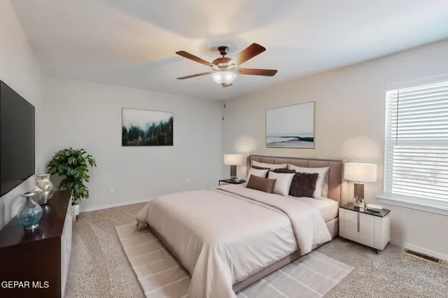 a bedroom with a bed and a potted plant