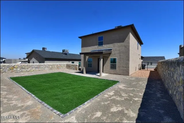 a view of a backyard with a garden and deck