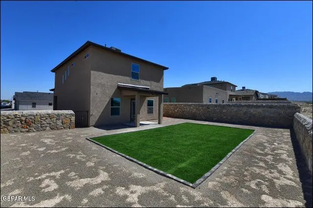 a view of a dry yard with mountains in the background