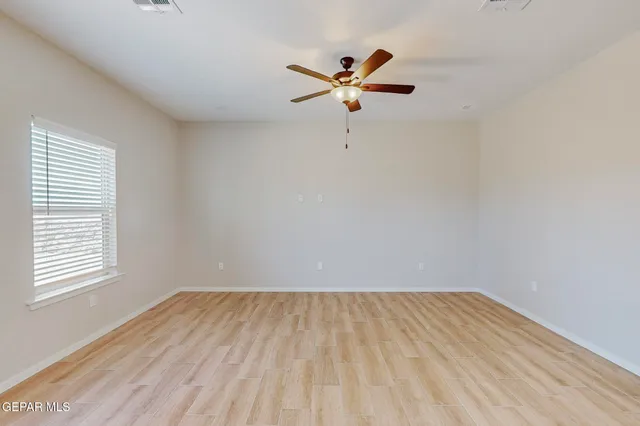 wooden floor in a room next to a window