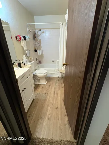 a bathroom with a sink a toilet and shower curtain