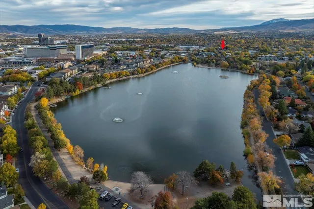 an aerial view of a city with lots of residential buildings lake and ocean view