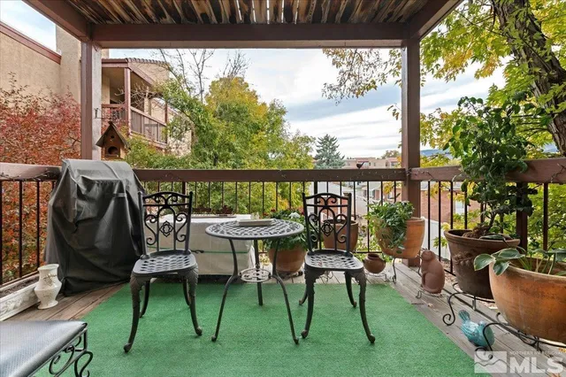 a balcony with chairs and a table