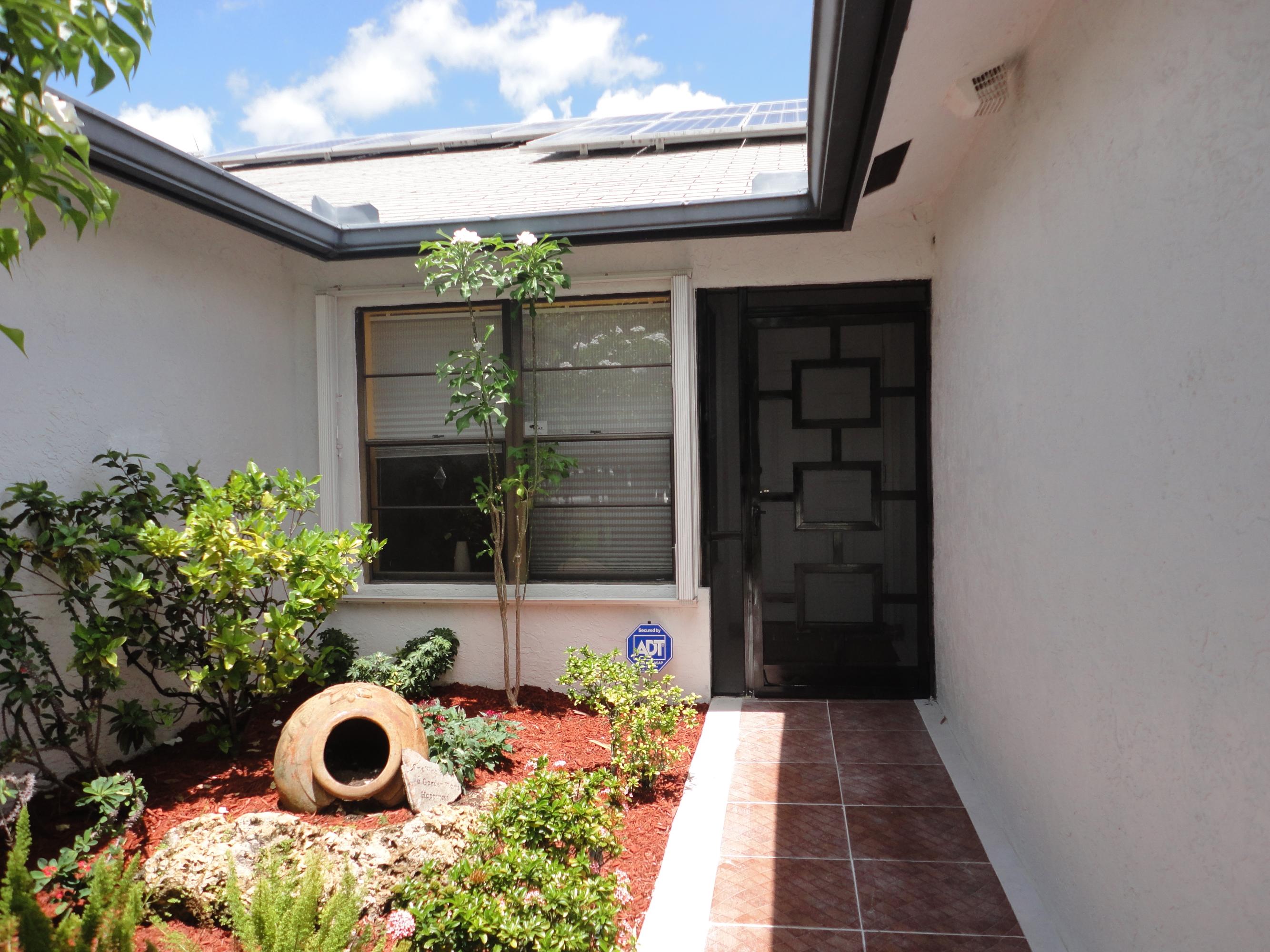 9793 Majorca Place Boca Raton, FL 33434 - Photo 2 of 41 Front View Garden (Solar Panels)
