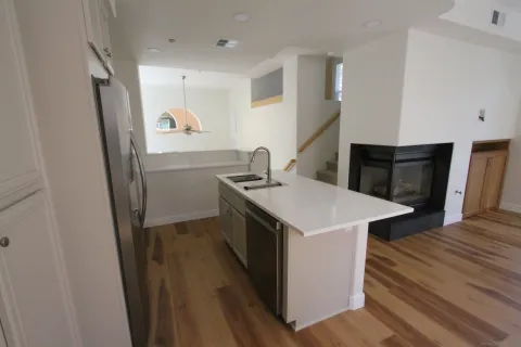 a bathroom with a granite countertop sink a mirror and shower