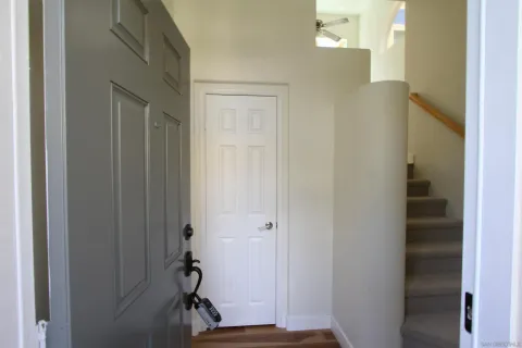 a view of an entryway with wooden floor