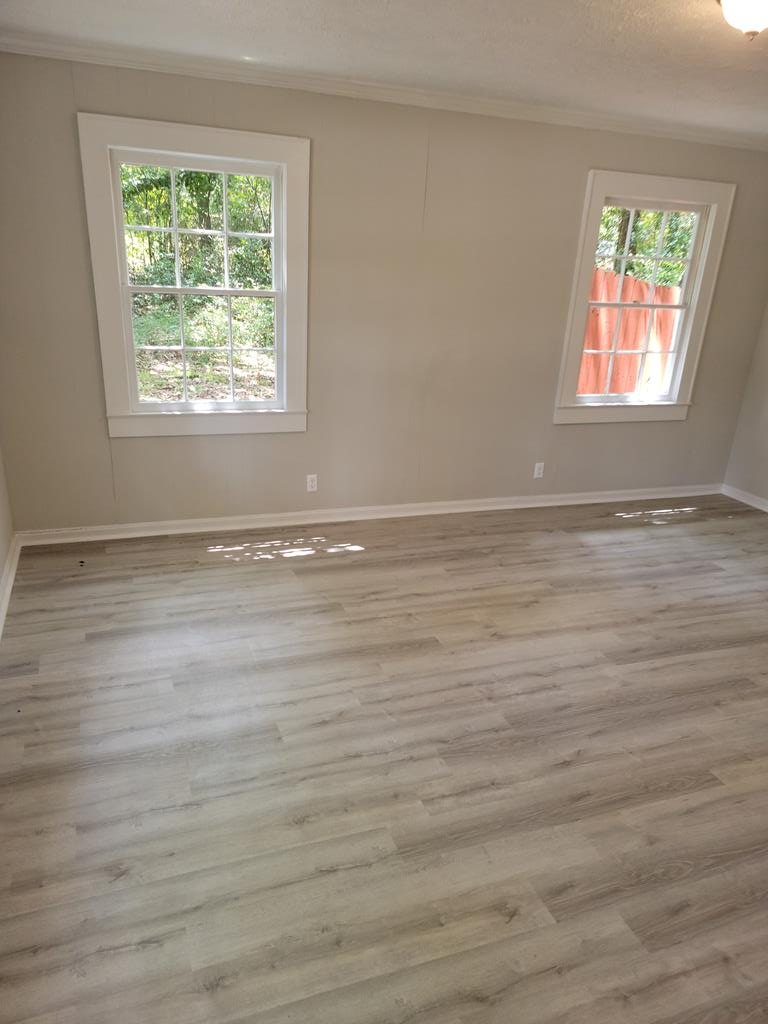 3643 Forrest Road Columbus, GA 31907 - Photo 11 of 12 a view of an empty room with wooden floor and a window