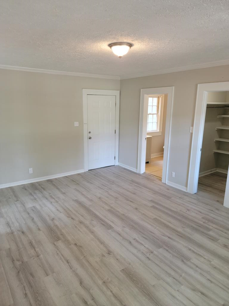3643 Forrest Road Columbus, GA 31907 - Photo 12 of 12 wooden floor in an empty room with a window