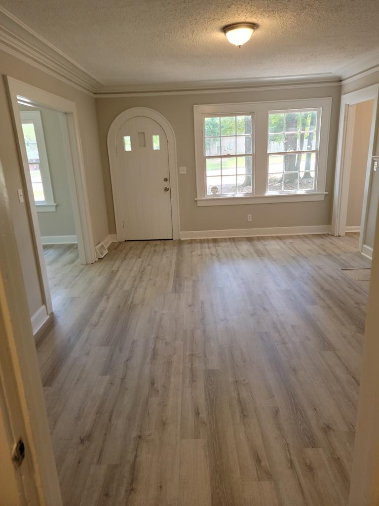 3643 Forrest Road Columbus, GA 31907 - Photo 2 of 12 an empty room with wooden floor and windows