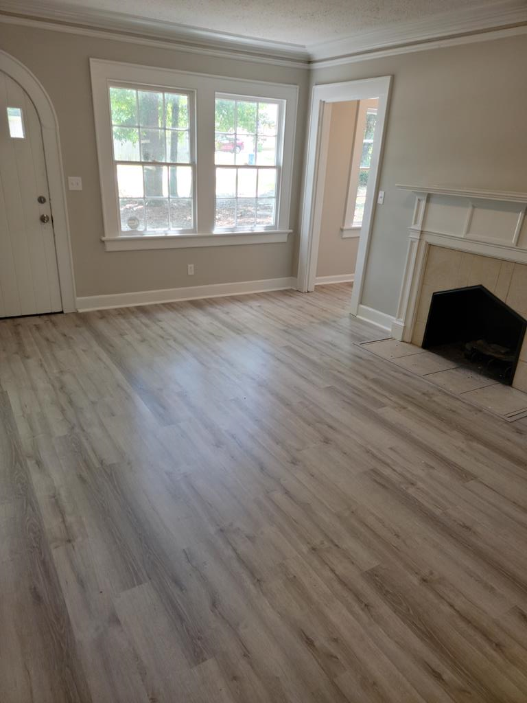 3643 Forrest Road Columbus, GA 31907 - Photo 3 of 12 an empty room with wooden floor fireplace and windows