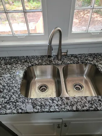 a close view of sink sitting inside of a cabinet