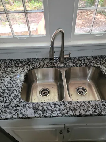 a close view of sink sitting inside of a cabinet