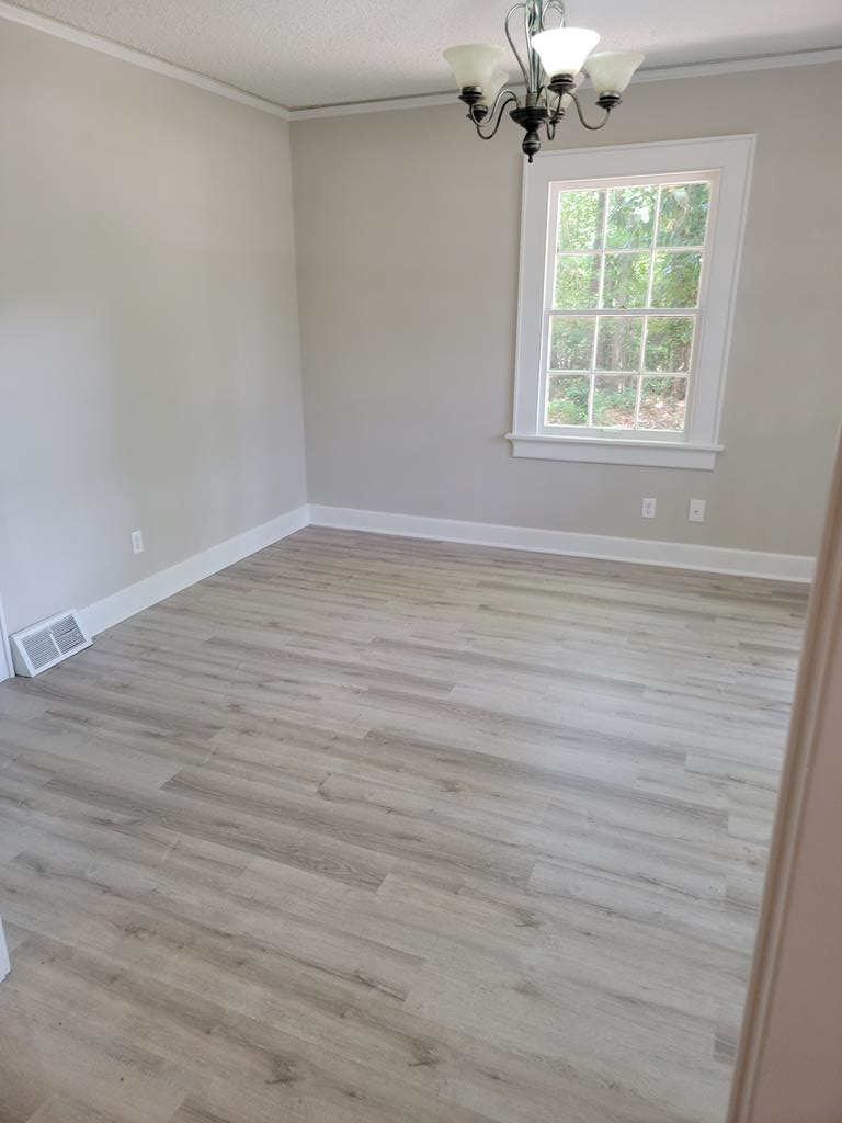 3643 Forrest Road Columbus, GA 31907 - Photo 9 of 12 wooden floor in an empty room with a window