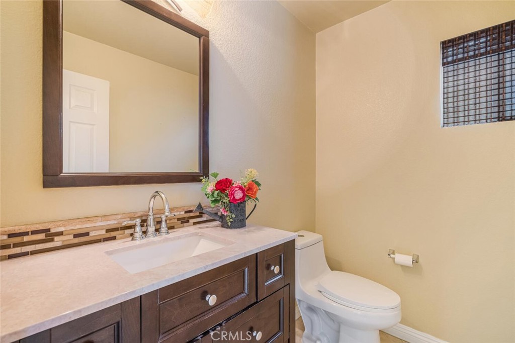 17262 Hawkwood Drive Riverside, CA 92503 - Photo 12 of 33 a bathroom with a sink vanity mirror and toilet