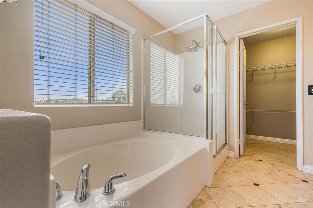 17262 Hawkwood Drive Riverside, CA 92503 - Photo 18 of 33 a bathroom with a tub and a shower