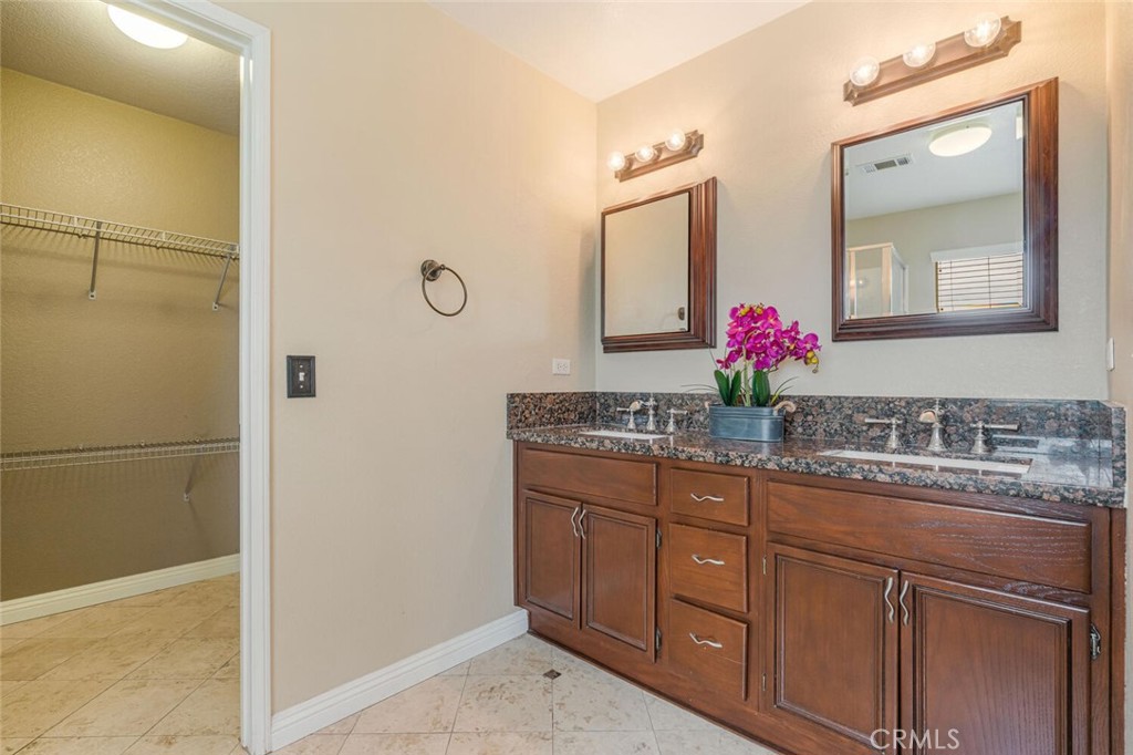 17262 Hawkwood Drive Riverside, CA 92503 - Photo 19 of 33 a bathroom with a granite countertop sink and a mirror