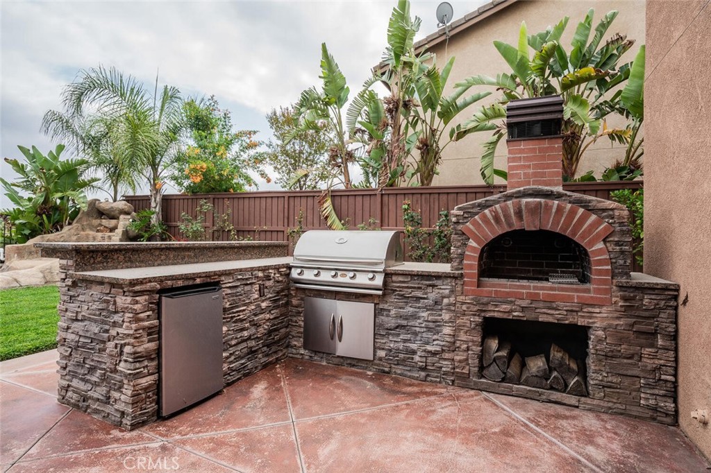 17262 Hawkwood Drive Riverside, CA 92503 - Photo 23 of 33 a view of a fireplace with a potted plant in front of house