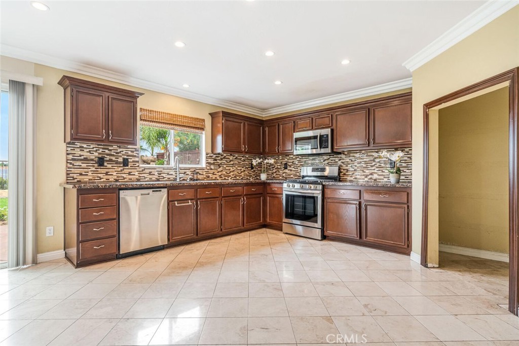 17262 Hawkwood Drive Riverside, CA 92503 - Photo 8 of 33 a kitchen with stainless steel appliances granite countertop a stove sink and cabinets