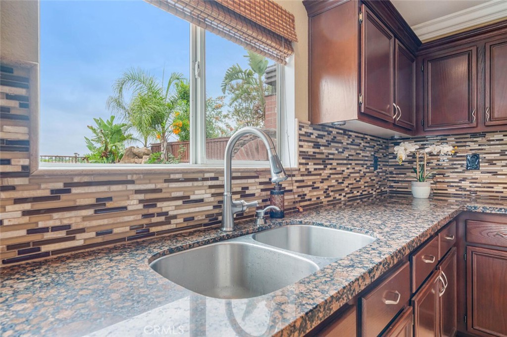 17262 Hawkwood Drive Riverside, CA 92503 - Photo 9 of 33 a kitchen with granite countertop a sink and a stove