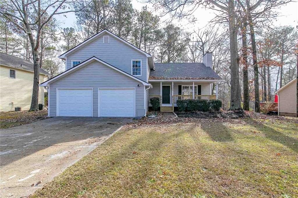 3320 Caley Mill Drive Powder Springs, GA 30127 - Photo 1 of 1 a front view of a house with a yard and garage