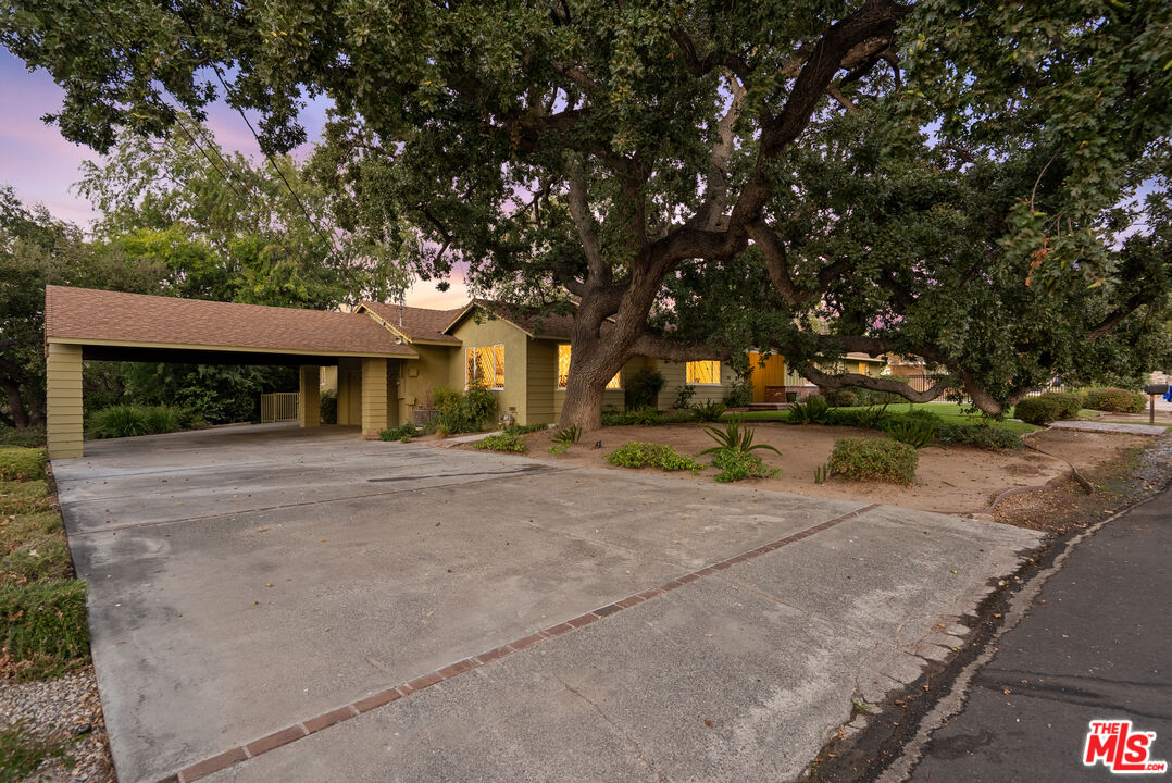 a view of a house with a yard and garage