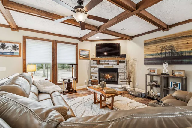 a view of a bedroom with furniture and next to a window
