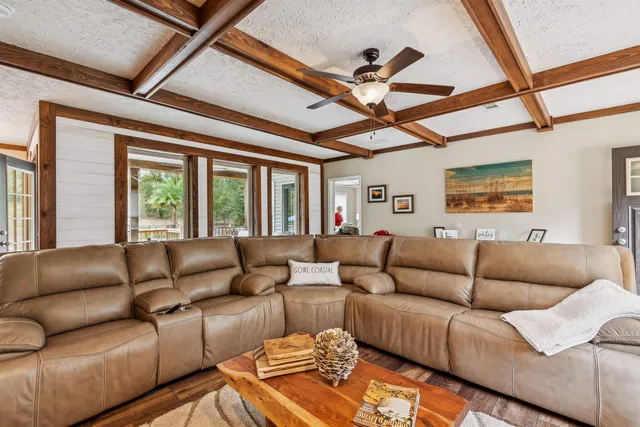 a view of a chairs and table under an umbrella in backyard