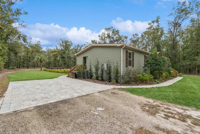 a kitchen with stainless steel appliances granite countertop a sink and wooden cabinets