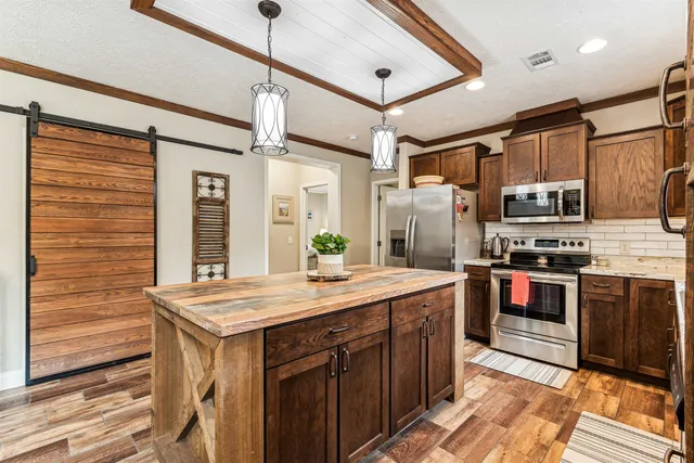 a view of a dining room with furniture large windows and wooden floor