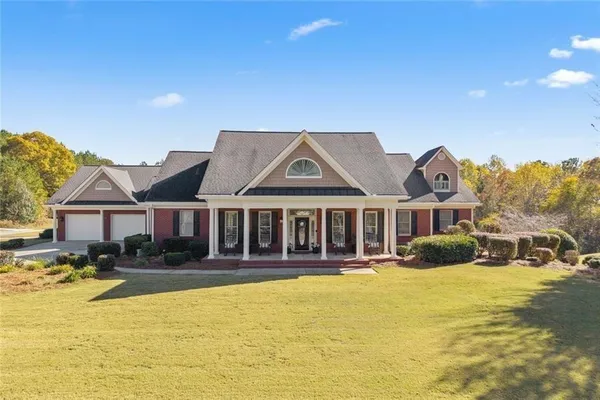 a front view of a house with a yard