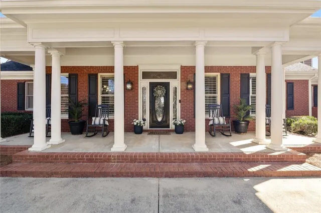 a living room with furniture wooden floor and a flat screen tv