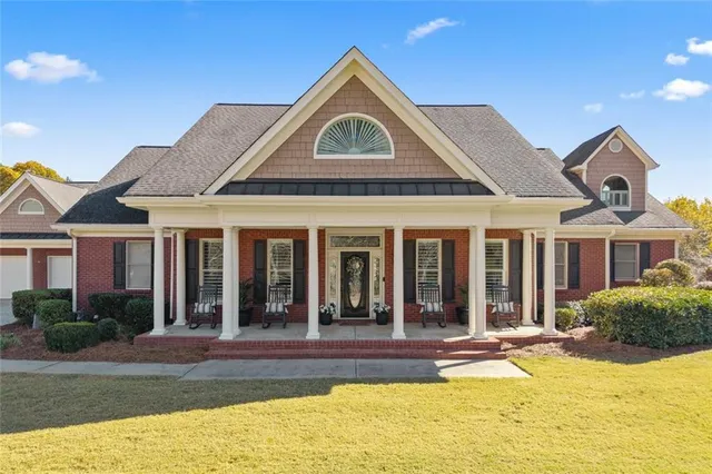 a view of a house with pool and sitting area